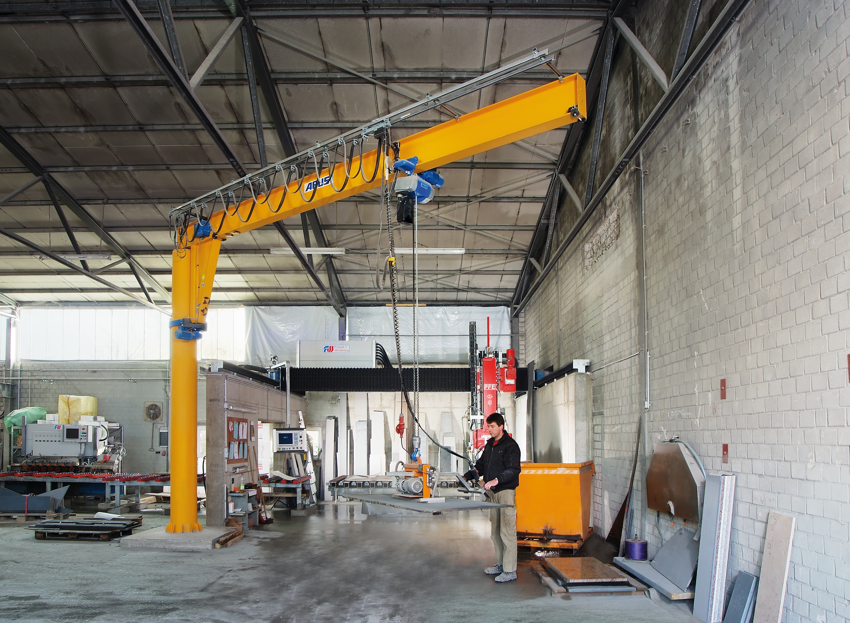 Industrial wall-mounted jib crane in operation